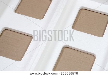 Background Image With Beige Cardboard Paper And Styrofoam Boxes Disgarded As Rubbish. The Concept Of