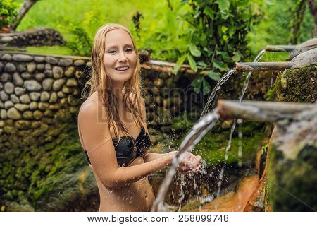 Young Woman Tourist In Belulang Hot Springs In Bali On The Background Of Rice Terraces