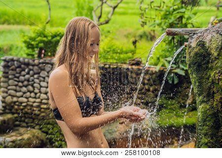 Young Woman Tourist In Belulang Hot Springs In Bali On The Background Of Rice Terraces