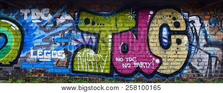 Full And Acomplished Graffiti Artwork. The Old Wall Decorated With Paint Stains In The Style Of Stre
