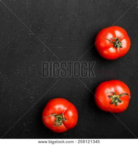 Hree Ripe Tomatoes On Black Background. The Whole Vegetable, Close Up