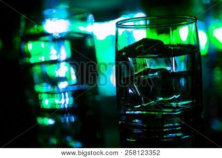 Colored Lighting Of Glasses In The Night Club Bar