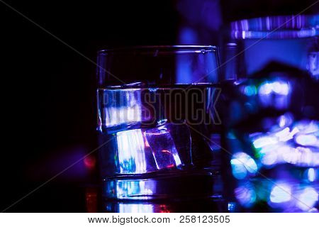 Colored Lighting Of Glasses In The Night Club Bar