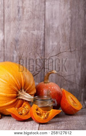 Utumn, Colored Pumpkins And Honey . Halloween Or Thanksgiving Concept