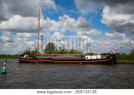 Sneek, Friesland, The Netherlands - August 11, 2018; Dutch traditional ship near Sneek, Friesland, The Netherlands
