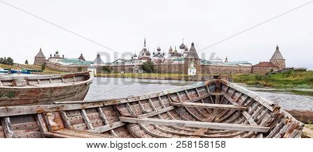 Panorama Of The Solovetsky Monastery With Old Broken Boats On The Foreground In Inclement Weather, B
