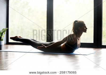 Young Sporty Woman Doing Yoga Salabhasana Pose