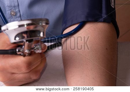 Hypertensive Patient Performing A Blood Pressure Auto Test / Man Self-monitoring Of Blood Pressure W