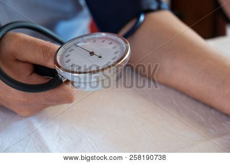 Hypertensive Patient Performing A Blood Pressure Auto Test / Man Self-monitoring Of Blood Pressure W