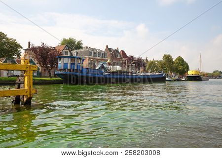 Zaanse Schans, Netherlands, August 19, 2015 - Traditional Dutch Buildings And Boats At The Canal.