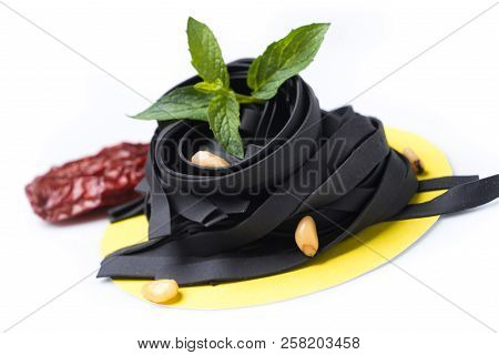Uncoocked Black Tagliatelle On Gastronomic Plate Composition