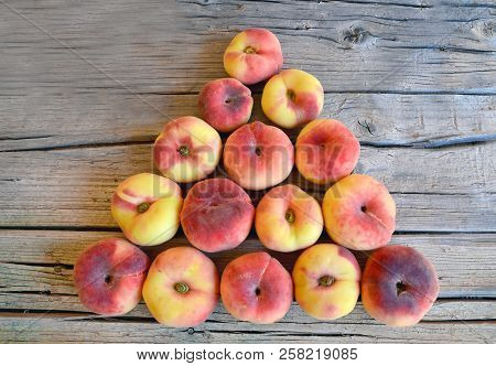 Chinese Flat Donut Peaches With Leaves On Old Wooden Table Also Known As Saturn Donut, Doughnut,para