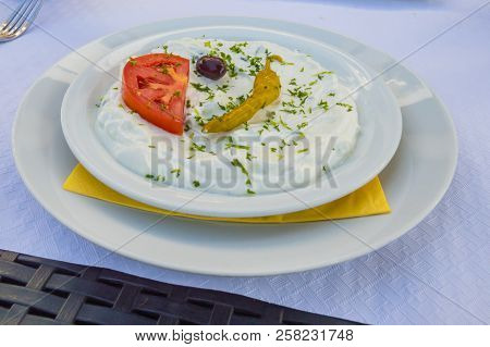 Plate Of Tzatziki With A Tomato And An Olive In A Restaurant Of Florenville In The South Of Belgium