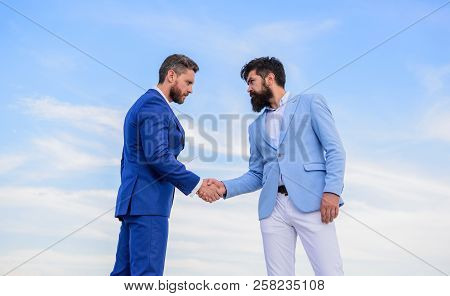 Sure Sign You Should Trust Business Partner. Men Formal Suits Shaking Hands Blue Sky Background. Ent