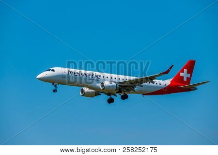 Zurich, Switzerland - July 19, 2018: Helvetic Swiss airlines airplane preparing for landing at day time in international airport