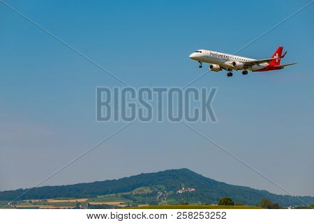 Zurich, Switzerland - July 19, 2018: Helvetic Swiss airlines airplane preparing for landing at day time in international airport