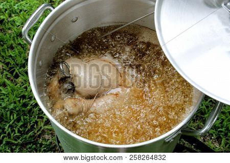 Large Turkey Frying In A Large Pot Of Oil.