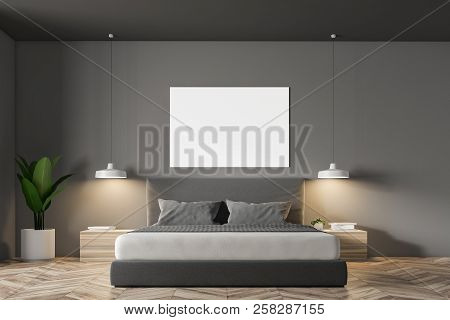Gray Wall Minimalistic Bedroom Interior With A Wooden Floor, Masterbed Standing On It And Night Stan