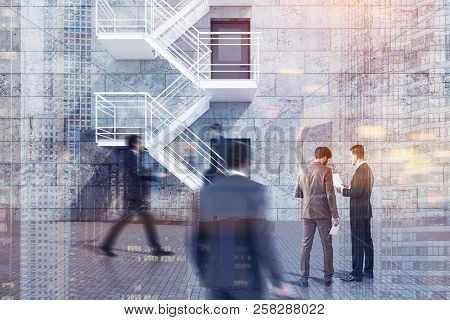 Modern Building Exterior With Concrete Brick Walls, Grey Doors And Emergency Exit Stairs. Businessme