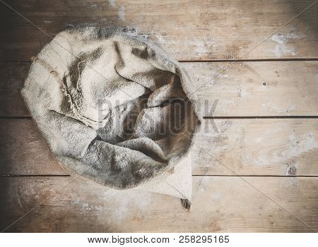 Burlap Bag Of White Wholemeal Flour On Wooden Rustic Boards Background Top View