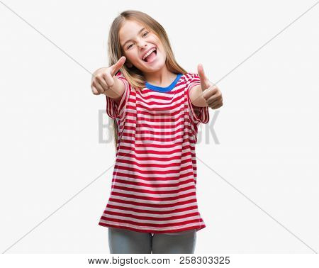 Young beautiful girl over isolated background approving doing positive gesture with hand, thumbs up smiling and happy for success. Looking at the camera, winner gesture.