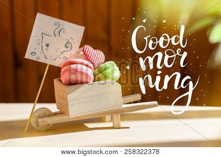 Morning Surprise, Colored Cakes Makarons With A Card. The Inscription Is A Good Morning. Sun Rays