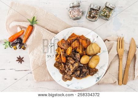 Beef meat stewed with potatoes-Traditional French cuisine Beef Bourguignon potatoes carrots in persillade