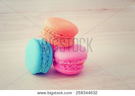 Pastel Color Of  Sweet Macaroons On Wooden Background In Soft Focus
