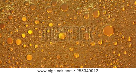 Cooking Oil, Water With Oil Emulsions And Bubbles In The Background.