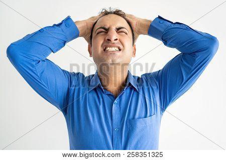 Portrait Of Concerned Mid Adult Businessman Touching Chin. Indian Man Getting Interested With Offer.
