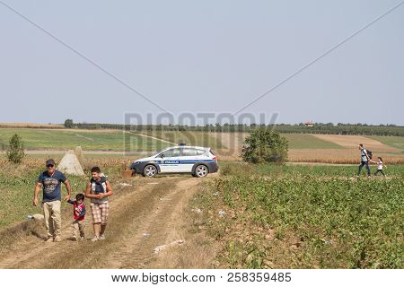Tovarnik, Croatia - September 19, 2015: Group Of Refugees, From Passing In Front Of A Croatian Polic