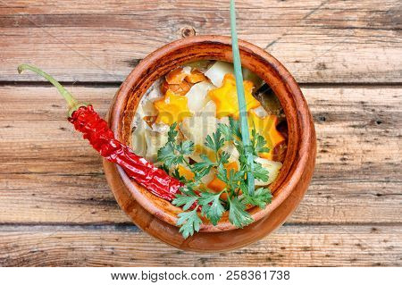 Traditional Rustic Home  Gulyas, With Raw Vegetables And Spices In Clay Pots On  Wooden Table.