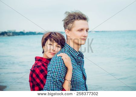 Portraits Of Romantic Couple On The Sea Beach Embracing Each Other. Concept Of Lovers Happy Moments 