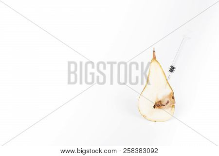 Close-up Boring Trace Of A Codling Moth Cydia Pomonella, In A Half Middle Wormy Pear. On White Backg