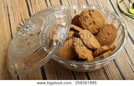A Bowl Of Choco Chips Cookies On White Wooden Table