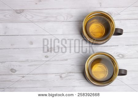 Two Cups Of Tea On A White Wooden Surface