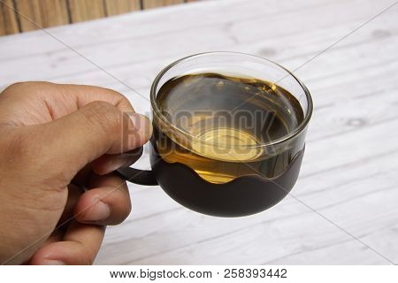 Men's Hand Holding A Cup Of Green Tea To Drink