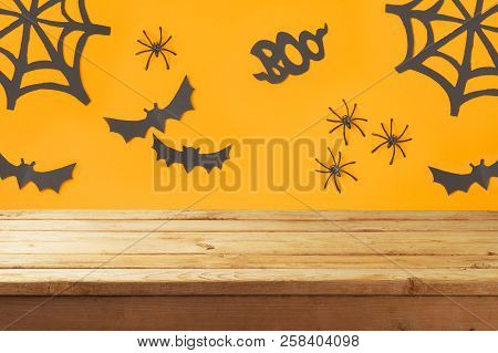 Empty Wooden Table Over Halloween Holiday Decorations Background