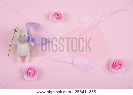 Tiny Unicorn Toy Made Of Wool, Handmade Rose Buds, Handmade Pink Leaves And A Pink Paper Card On A P