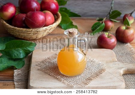 A Bottle Of Raw Unfiltered Apple Cider Vinegar On A Table