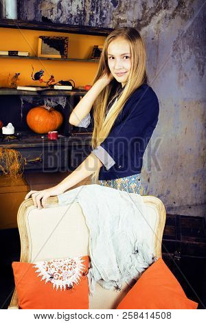 Young Pretty Teenage Girl In Halloween Holiday Decorated Interio