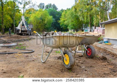 Two Jack-lifts Or Two-wheeled Construction Trucks Or Hand-carts In Construction Site For Carrying Gr
