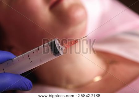 Cosmetologist Injecting Ozone To Chin. Patient Is Sitting In Chair With Closed Eyes. This Therapy Is