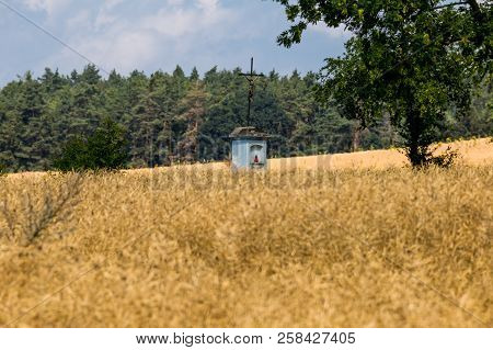 A Field With A Small Chapel