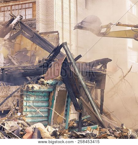 Demolition House Using Excavator In City. Rebuilding Process. Remove Equipment