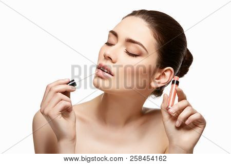 Girl Applying Pink Lipstick Isolated On White