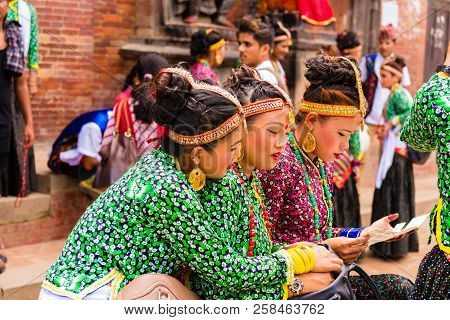 Group Of Dancers Wearing Traditional Costumes In Patan Durbar Square, Kathmandu Valley, Nepal