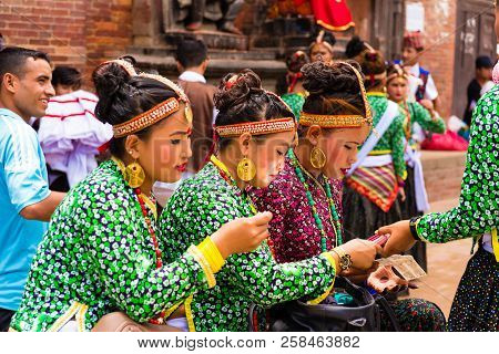Group Of Dancers Wearing Traditional Costumes In Patan Durbar Square, Kathmandu Valley, Nepal