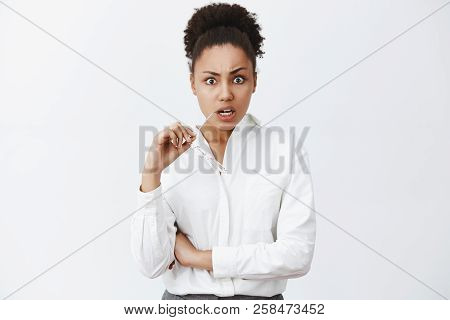 Woman Being Shocked Listening To Terrible News On Tv. Portrait Of Shook Displeased And Questioned Fe