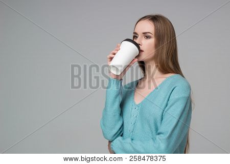 Girl In Aquamarine Jamper Drinking Coffee From Paper Plastic Glass